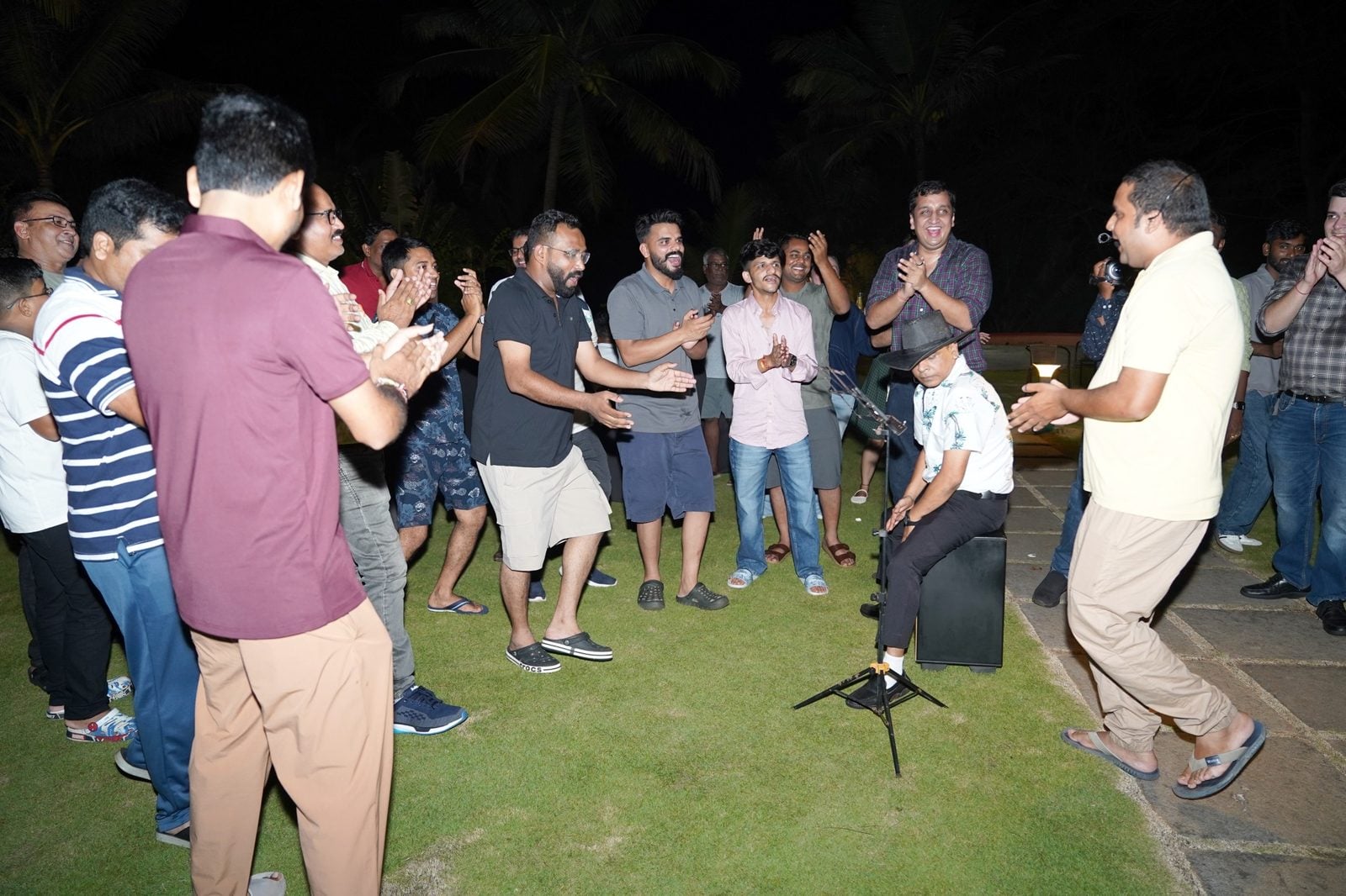 Partners dancing on the lawn with the band