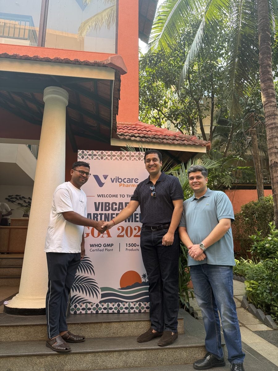 A Vibcare partner with the Vibcare team at the welcome standee