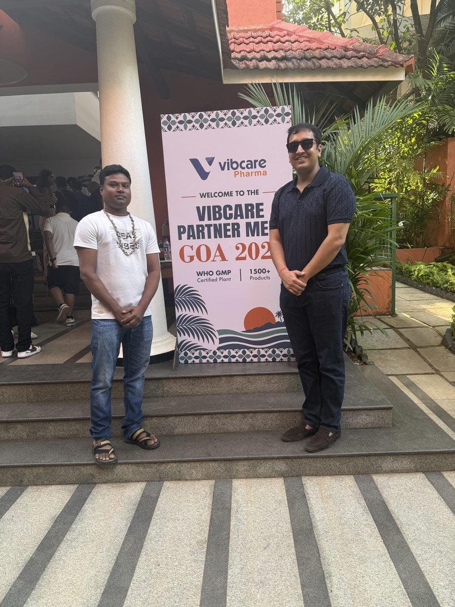 A Vibcare partner with the Vibcare team at the welcome standee